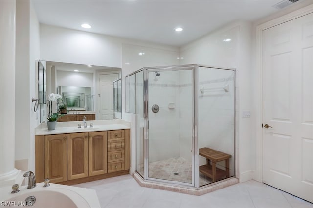 bathroom featuring vanity, walk in shower, and tile patterned floors