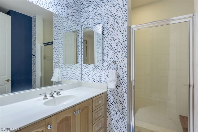 bathroom featuring an enclosed shower and vanity