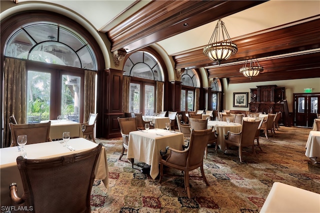 interior space featuring french doors, an inviting chandelier, and ornamental molding