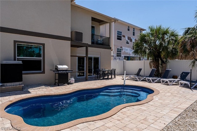 view of swimming pool featuring a grill, a patio, and central AC