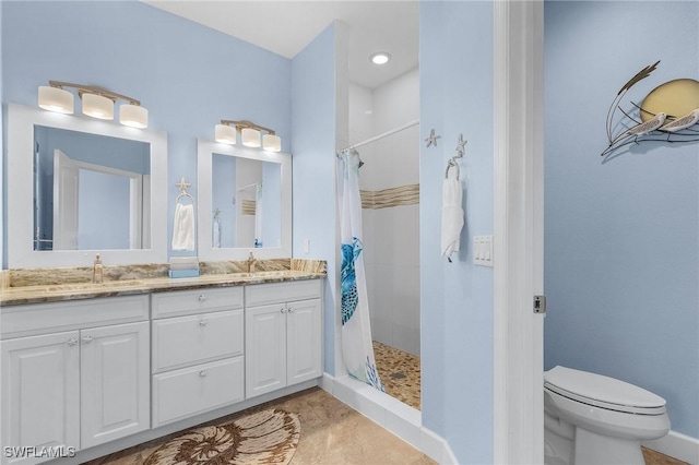 bathroom featuring tile patterned flooring, vanity, curtained shower, and toilet