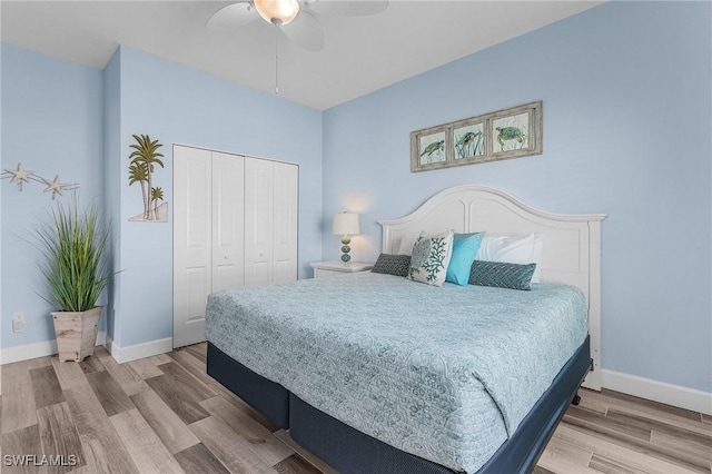 bedroom with light hardwood / wood-style floors, a closet, and ceiling fan