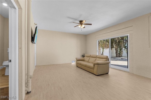 living room with ceiling fan and light hardwood / wood-style floors