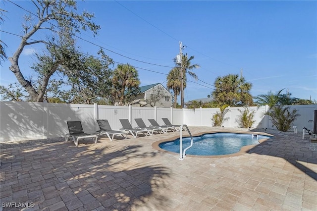 view of swimming pool with a patio area