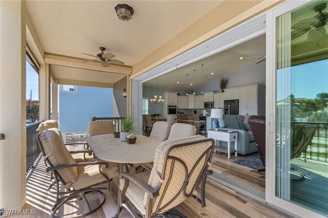 exterior space featuring ceiling fan with notable chandelier