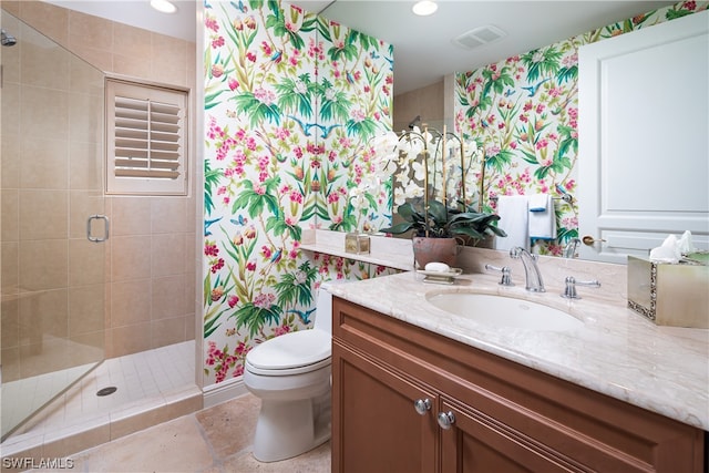 bathroom with a shower with door, vanity, and toilet