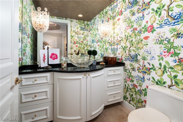 bathroom with vanity, toilet, and tile patterned flooring