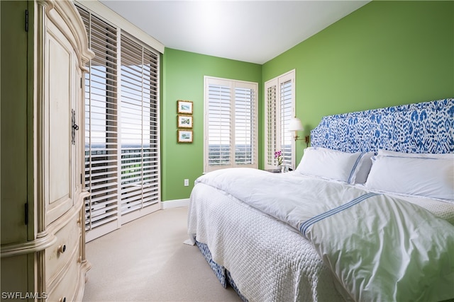 bedroom featuring light colored carpet