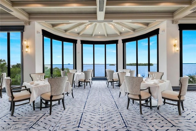 sunroom / solarium with a water view, a healthy amount of sunlight, coffered ceiling, and beamed ceiling