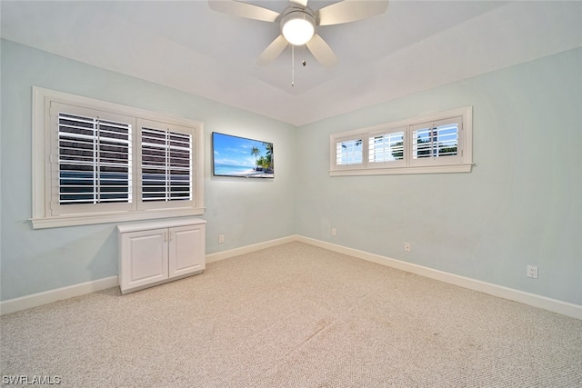 spare room with light carpet and ceiling fan