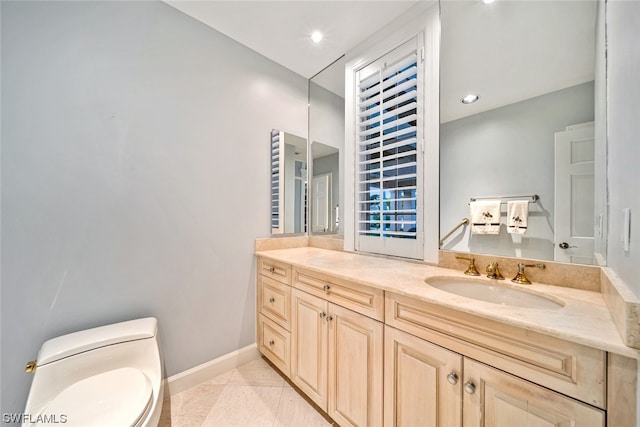 bathroom with toilet, vanity with extensive cabinet space, and tile flooring