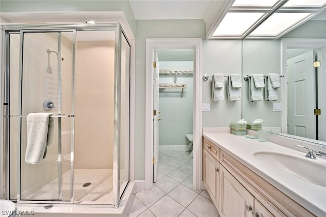 bathroom featuring oversized vanity, toilet, tile floors, and walk in shower