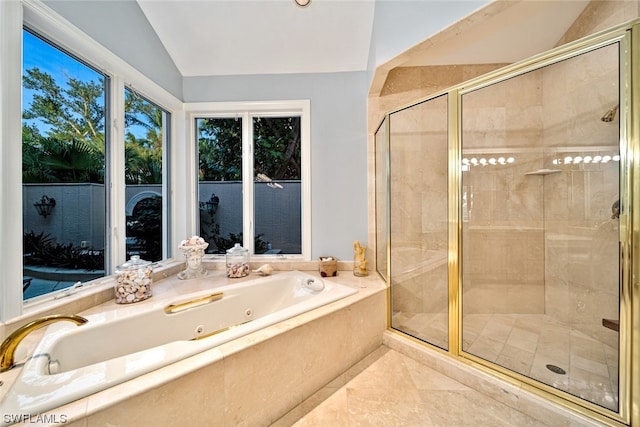 bathroom featuring vaulted ceiling, tile flooring, and separate shower and tub