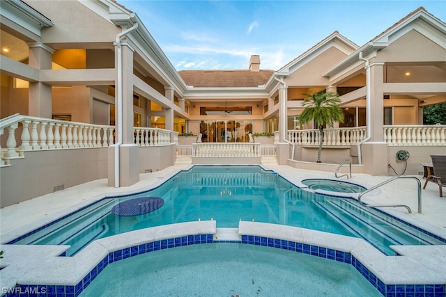 view of swimming pool with a patio and an in ground hot tub