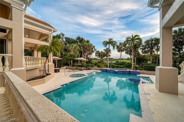 view of swimming pool featuring an in ground hot tub and a patio area