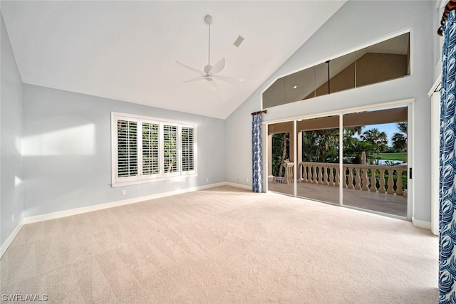 carpeted empty room featuring high vaulted ceiling and ceiling fan