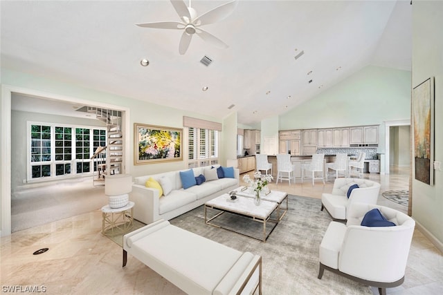 tiled living room featuring high vaulted ceiling, a healthy amount of sunlight, and ceiling fan