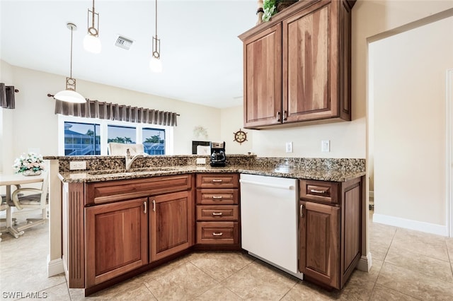 kitchen featuring dark stone countertops, dishwasher, sink, and light tile floors