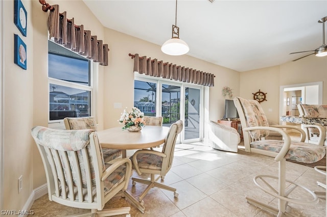 dining area featuring light tile flooring and ceiling fan