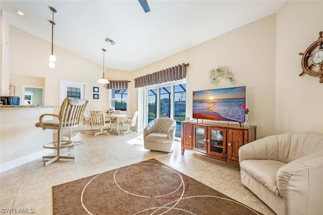 tiled living room with high vaulted ceiling