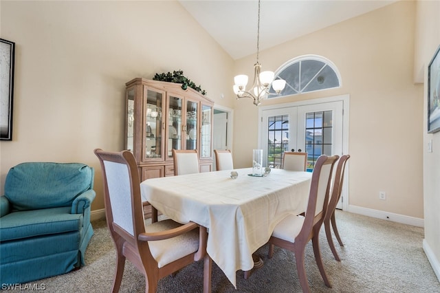 dining room with high vaulted ceiling, light colored carpet, a chandelier, and french doors