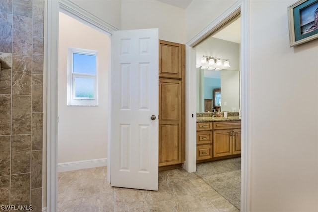 bathroom with tile floors and vanity