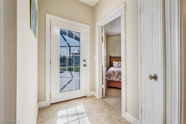 doorway to outside with light tile floors