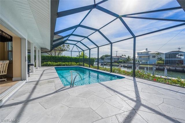 view of swimming pool with a water view, a patio area, and glass enclosure