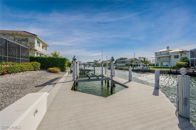 dock area featuring glass enclosure and a water view