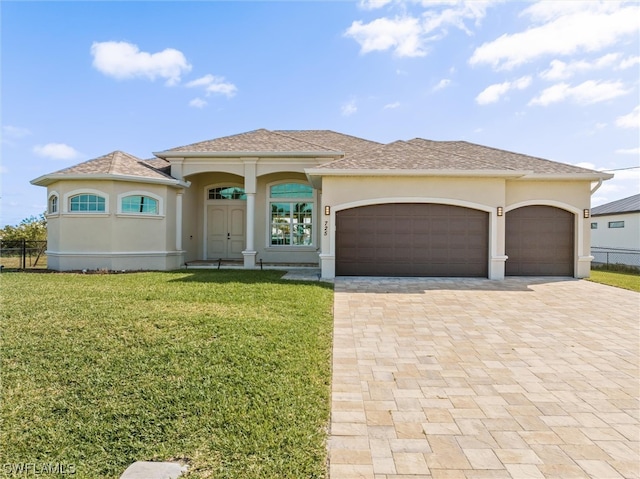 view of front of property with a garage and a front lawn