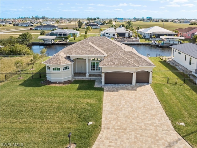 view of front facade with a front yard, a boat dock, and a water view