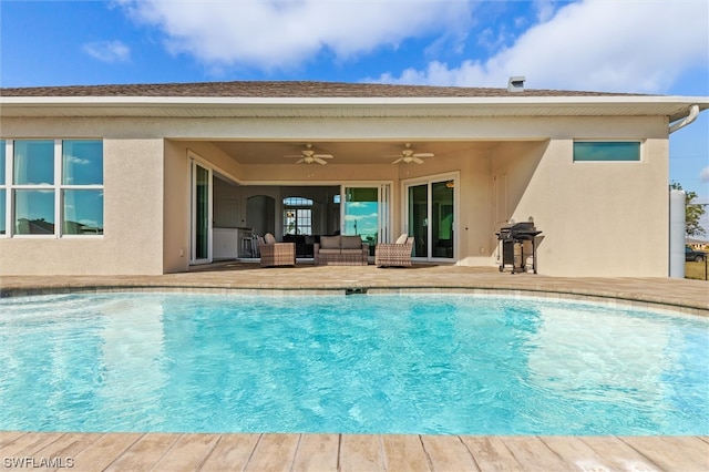 view of swimming pool with ceiling fan and a patio