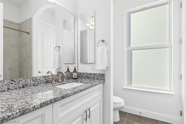 bathroom with vanity, toilet, and tile flooring