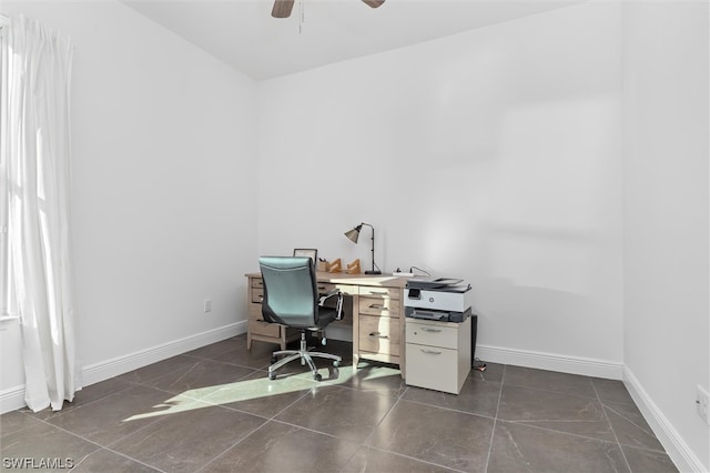 office space with ceiling fan and dark tile floors