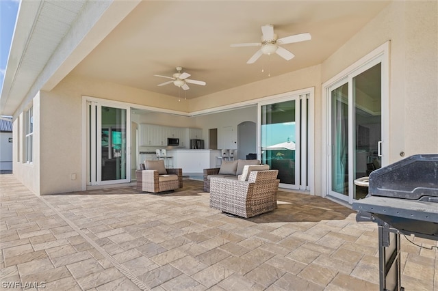 view of patio featuring area for grilling and ceiling fan