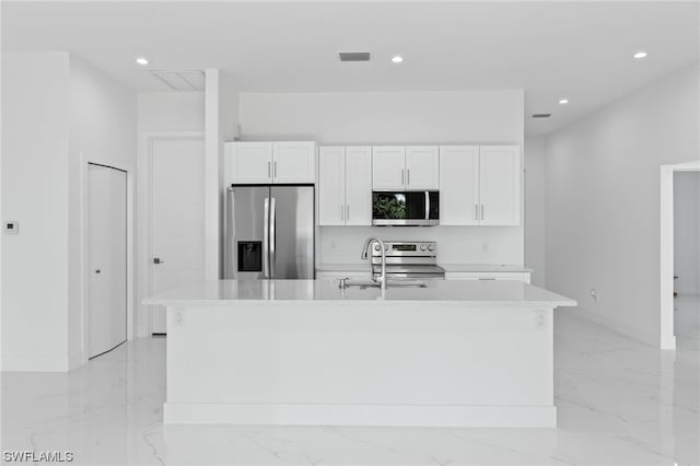 kitchen featuring sink, white cabinetry, a kitchen island with sink, light tile patterned floors, and stainless steel appliances