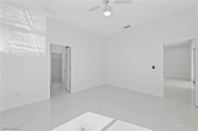 tiled empty room with ceiling fan