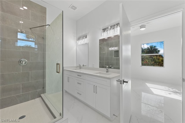 bathroom featuring tile patterned floors, an enclosed shower, and vanity