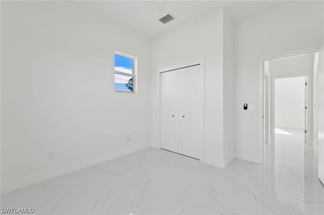 unfurnished bedroom featuring a closet and light tile patterned floors