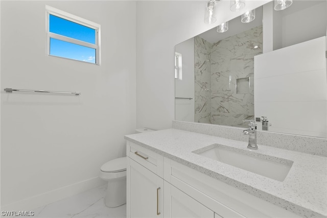 bathroom with tile patterned flooring, a tile shower, vanity, and toilet