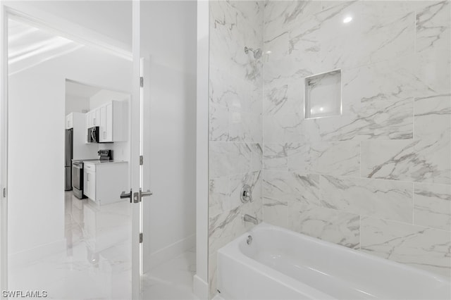 bathroom with tiled shower / bath combo and vanity