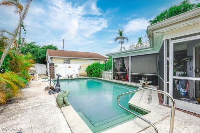 view of swimming pool featuring a patio area and a sunroom