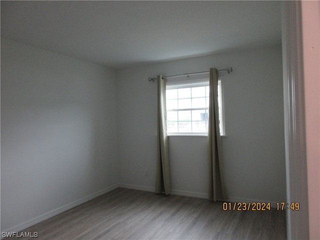 unfurnished room with light wood-type flooring