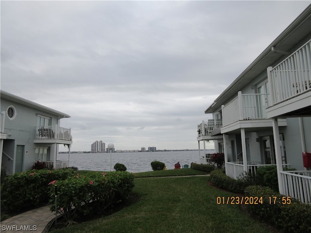 view of yard featuring a balcony and a water view