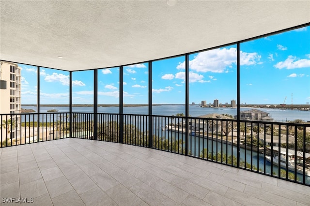 unfurnished sunroom with a water view