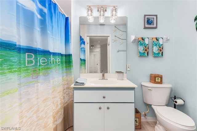 bathroom featuring tile flooring, toilet, and vanity