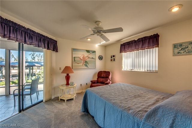 bedroom featuring dark carpet, ceiling fan, and access to outside