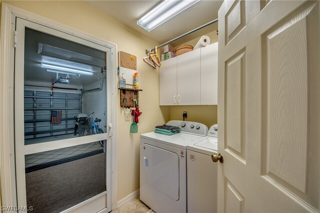 washroom featuring washing machine and dryer, cabinets, and hookup for an electric dryer