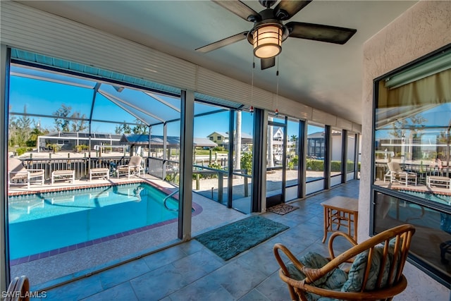 view of pool featuring ceiling fan, a patio, and a lanai