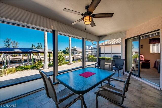 sunroom featuring ceiling fan